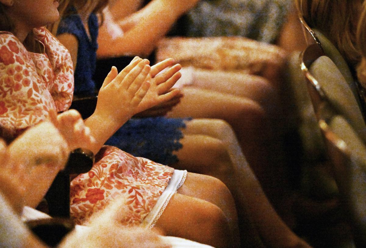 Audience members applaud