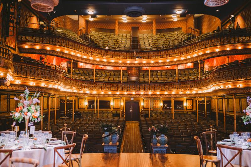 A rehersal dinner set on the stage of the historic opera house stage